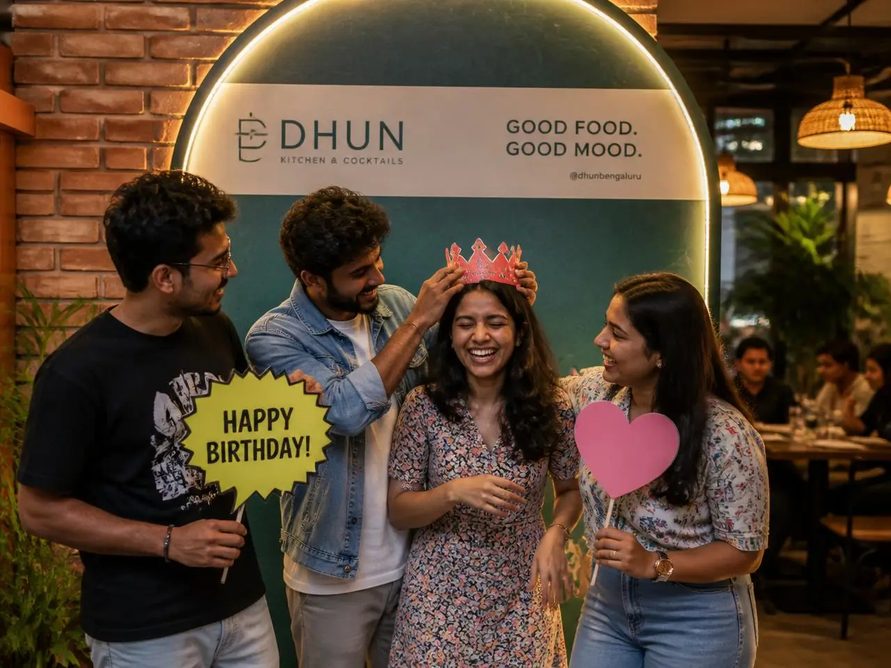 Friends celebrating a birthday at an amealio Selfie Wall in a rooftop restaurant in India
