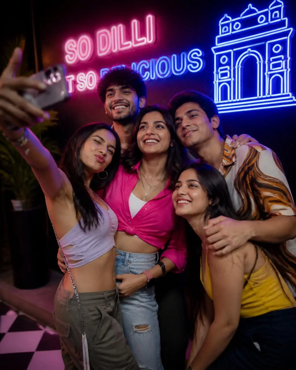 Friends at a neon memory wall